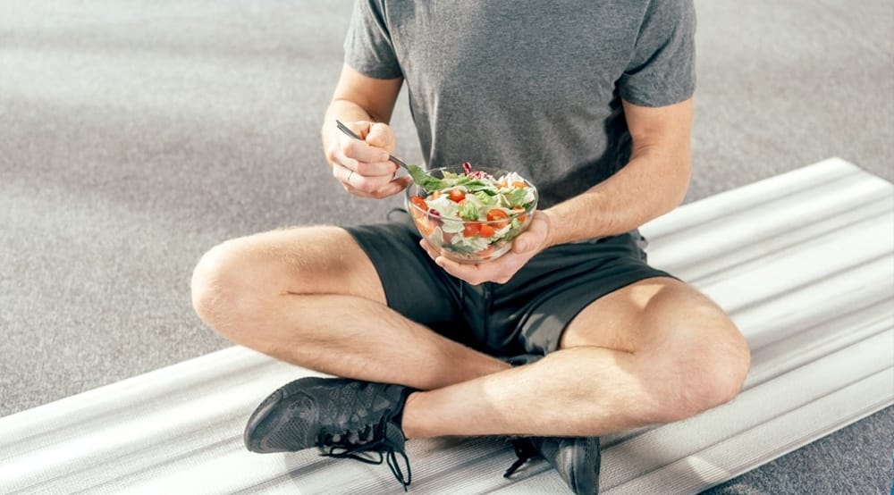 Man Sitting On Bench Eating Salad 2